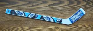 "I xplored Grasslands National Park" mini hockey stick, knee hockey stick, Blue designs with Parks Canada logo placed on the pictures of 4 hockey pucks along the handle of the hockey stick.